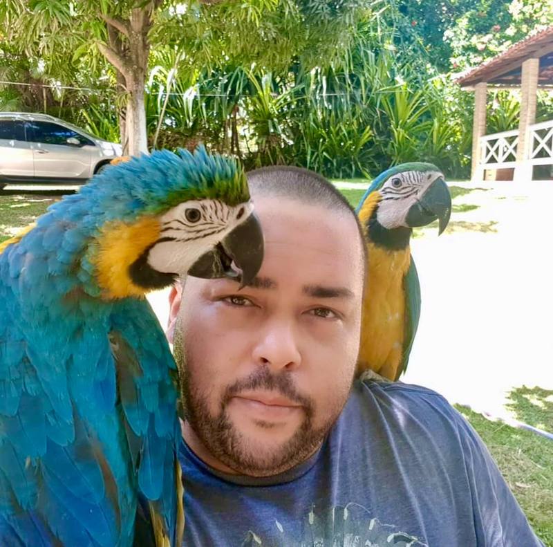 Breeder with Macaws